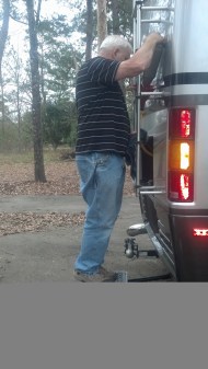 Roy changing Dora's oil on the broken table and milk crate!