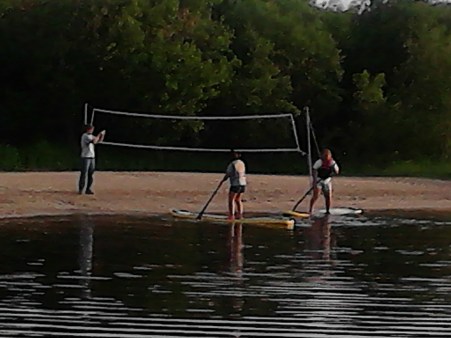 guests on surfboards launching